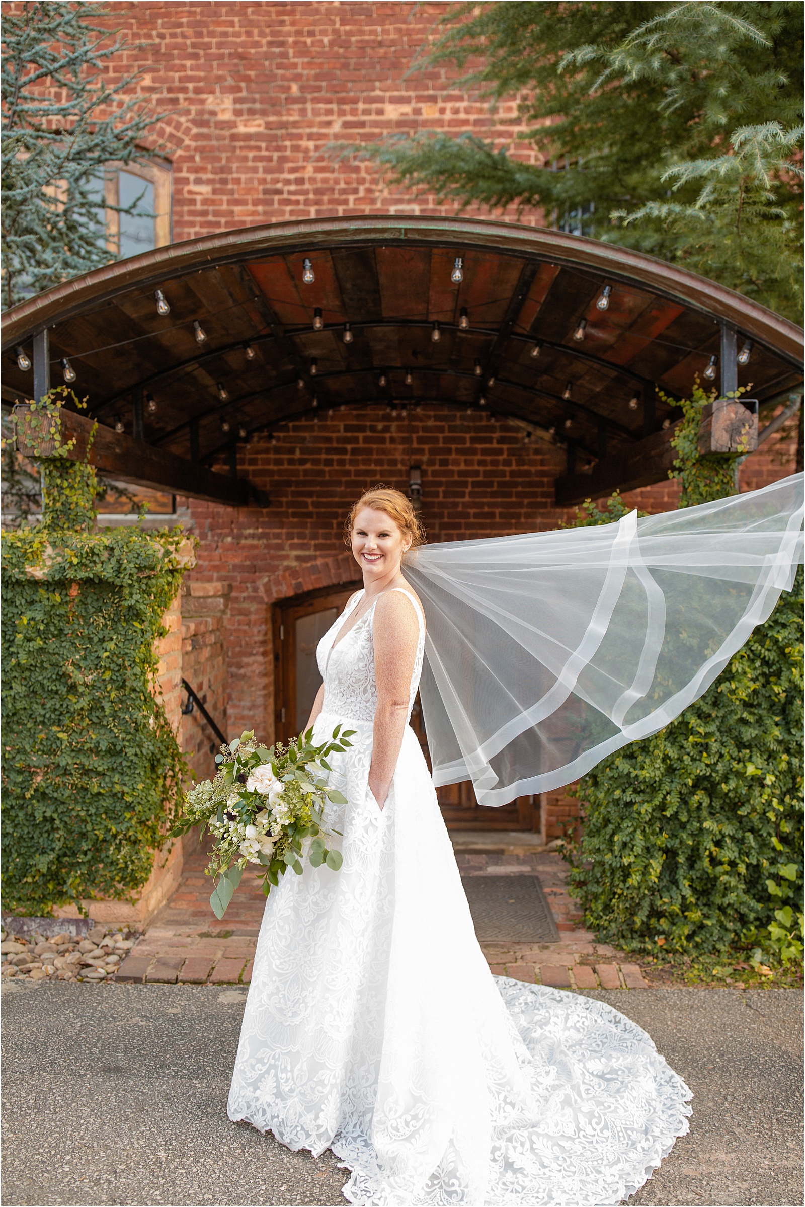 bride in wedding dress standing in front of old cigar warehouse venue