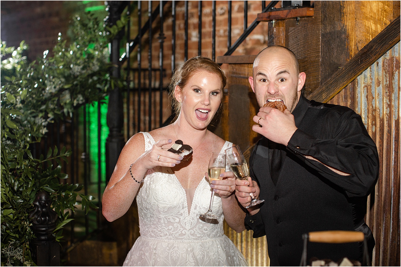 groom and bride eating donuts at their weddings