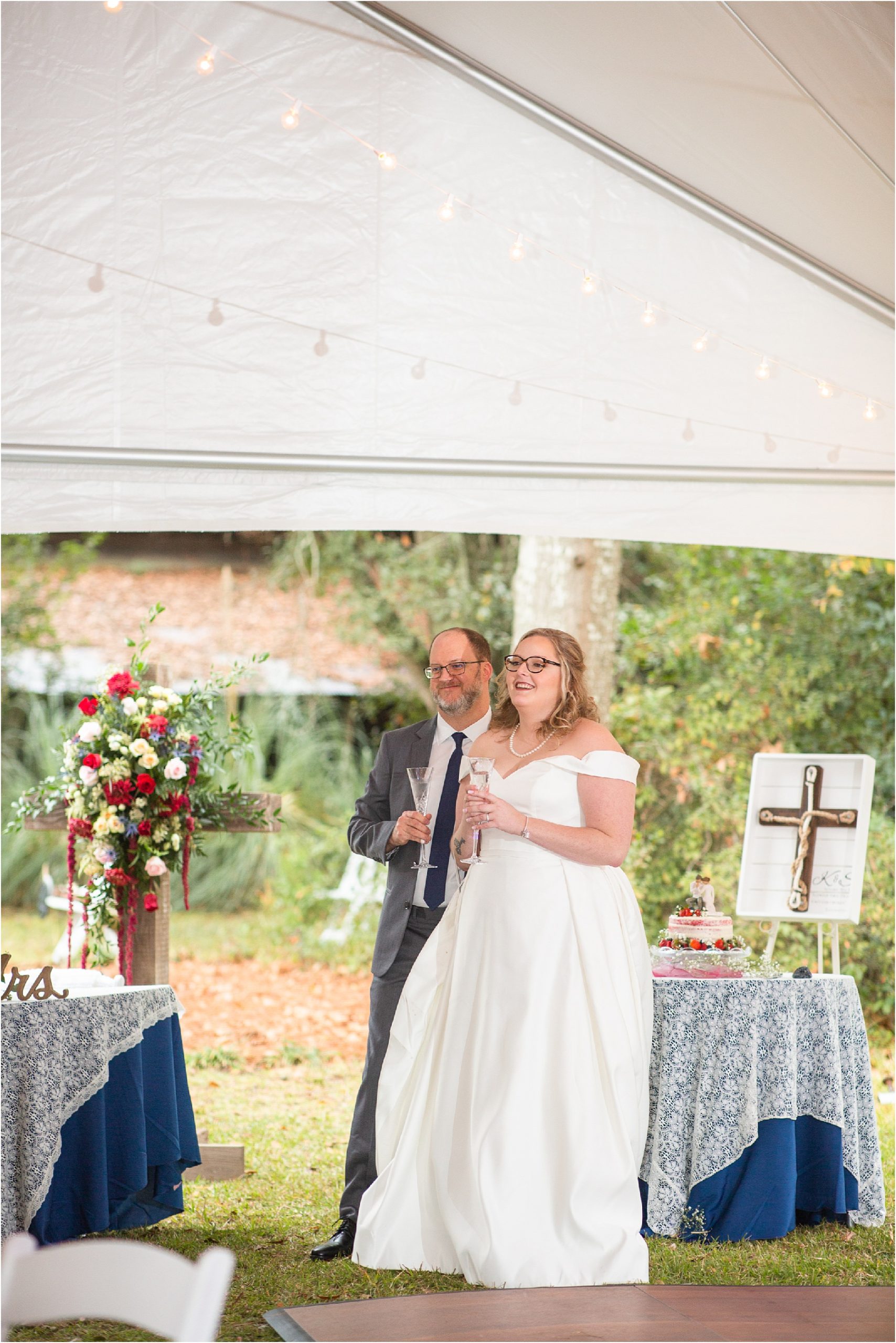 newlywed couple stands during toasts at reception