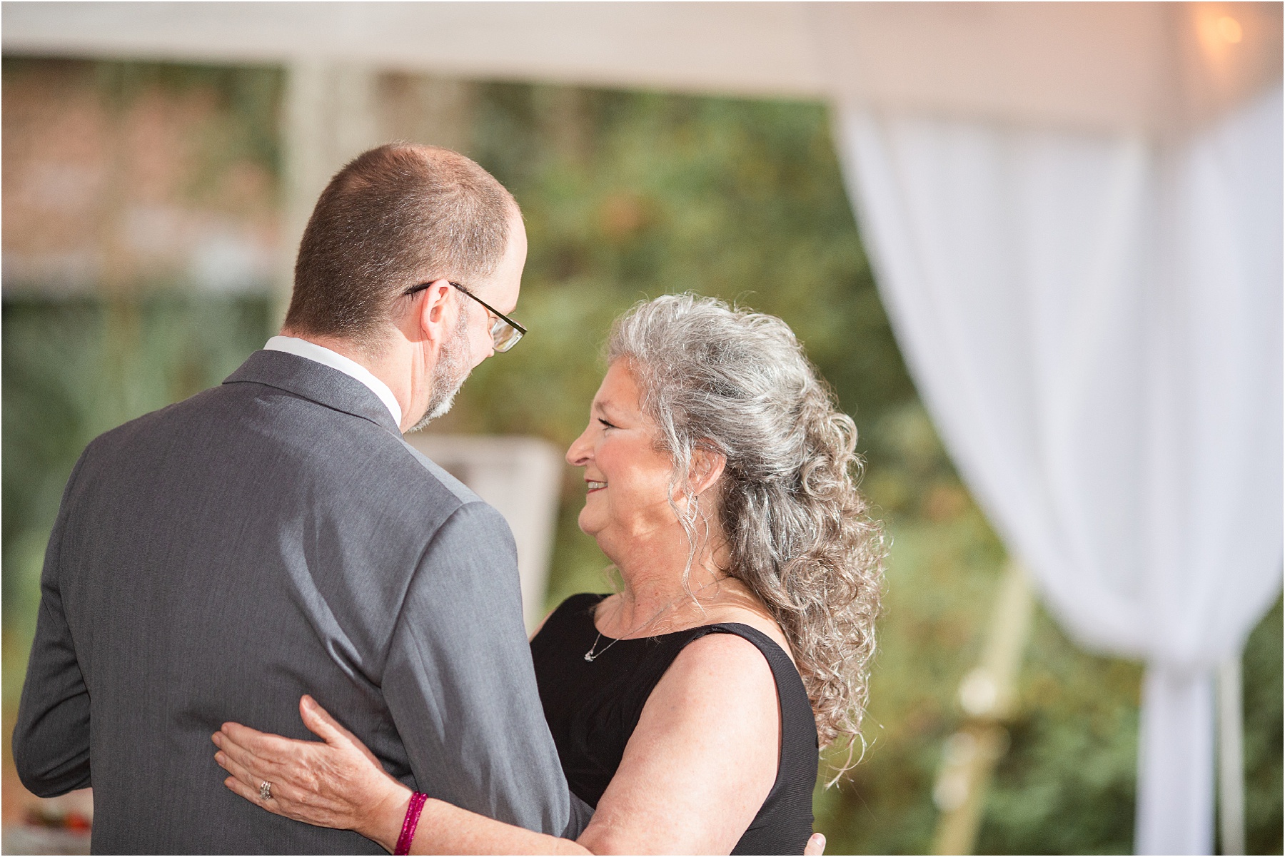 groom and mom dance at wedding reception