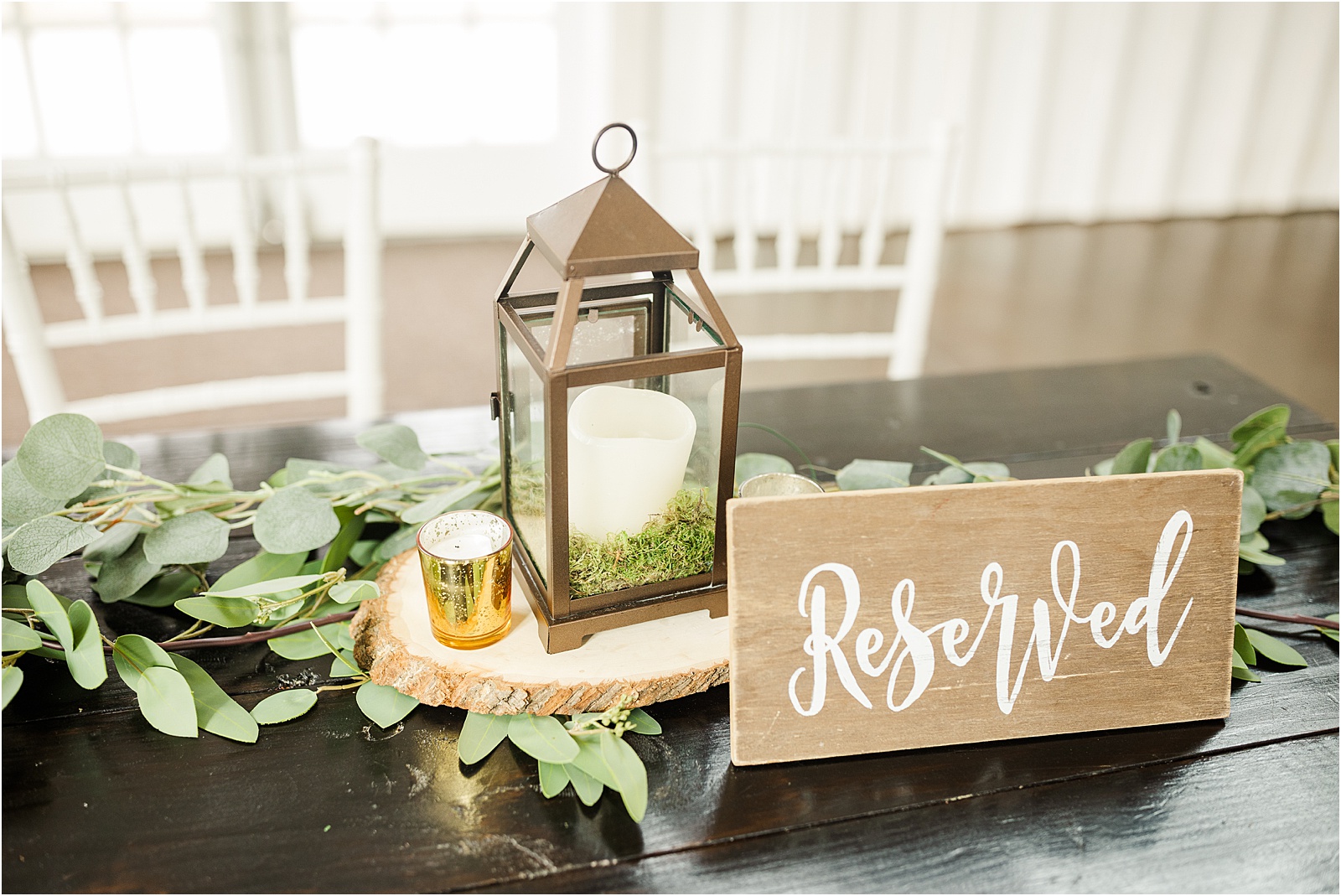 lantern and reserved sign at reception table