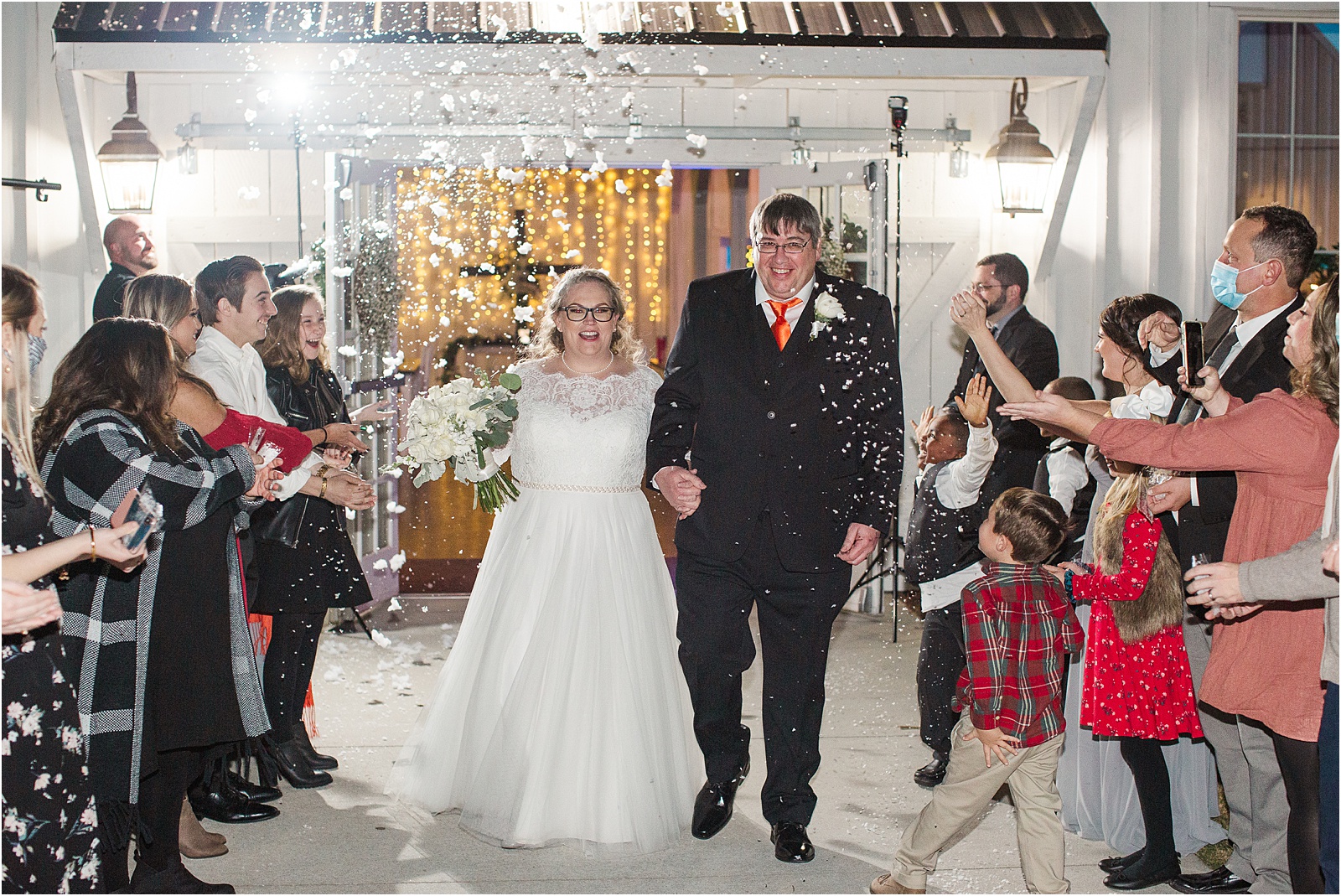 couple leaving wedding with snow thrown at them