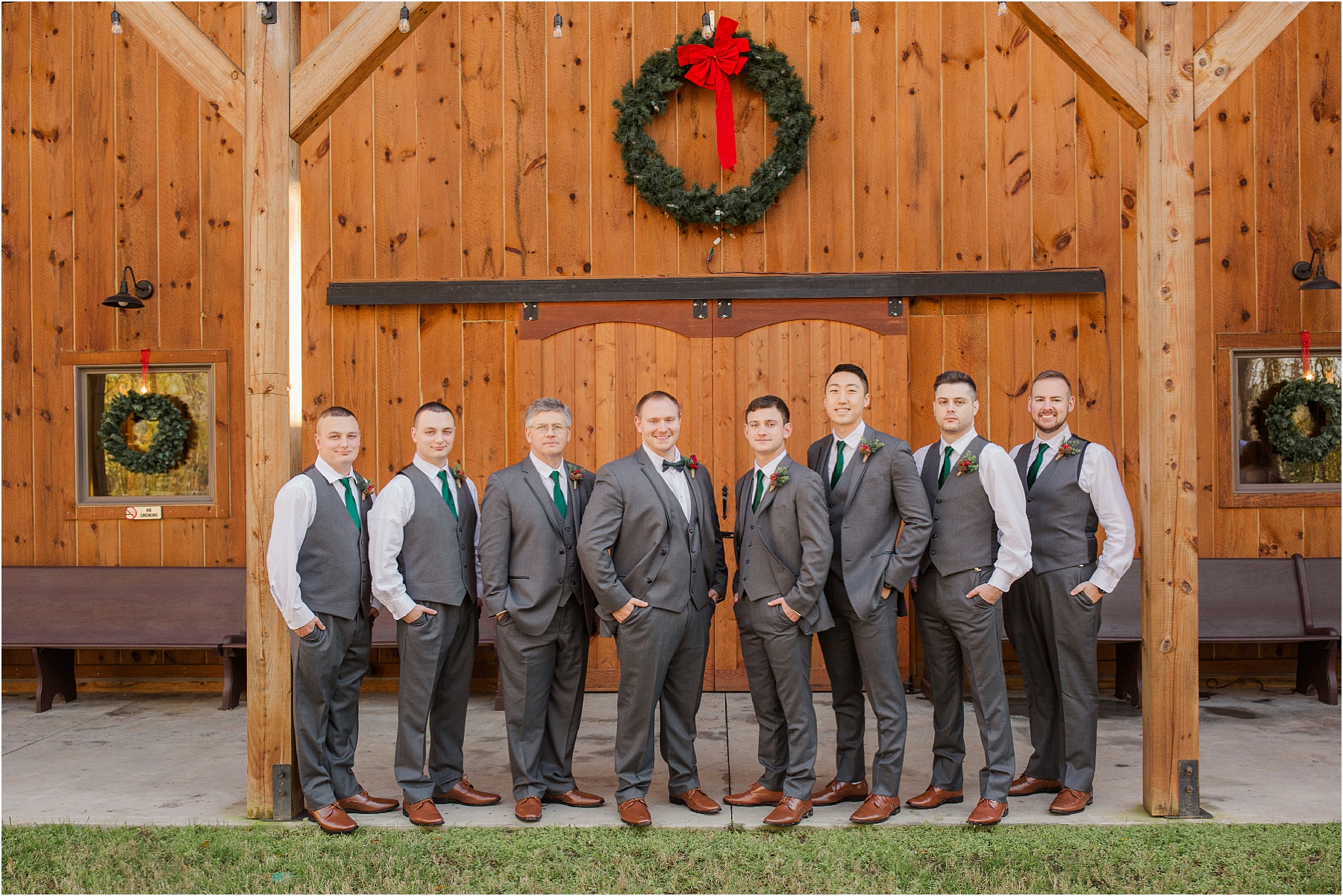 Group of groomsmen in grey standing next to a wooden barn in Greenwood SC