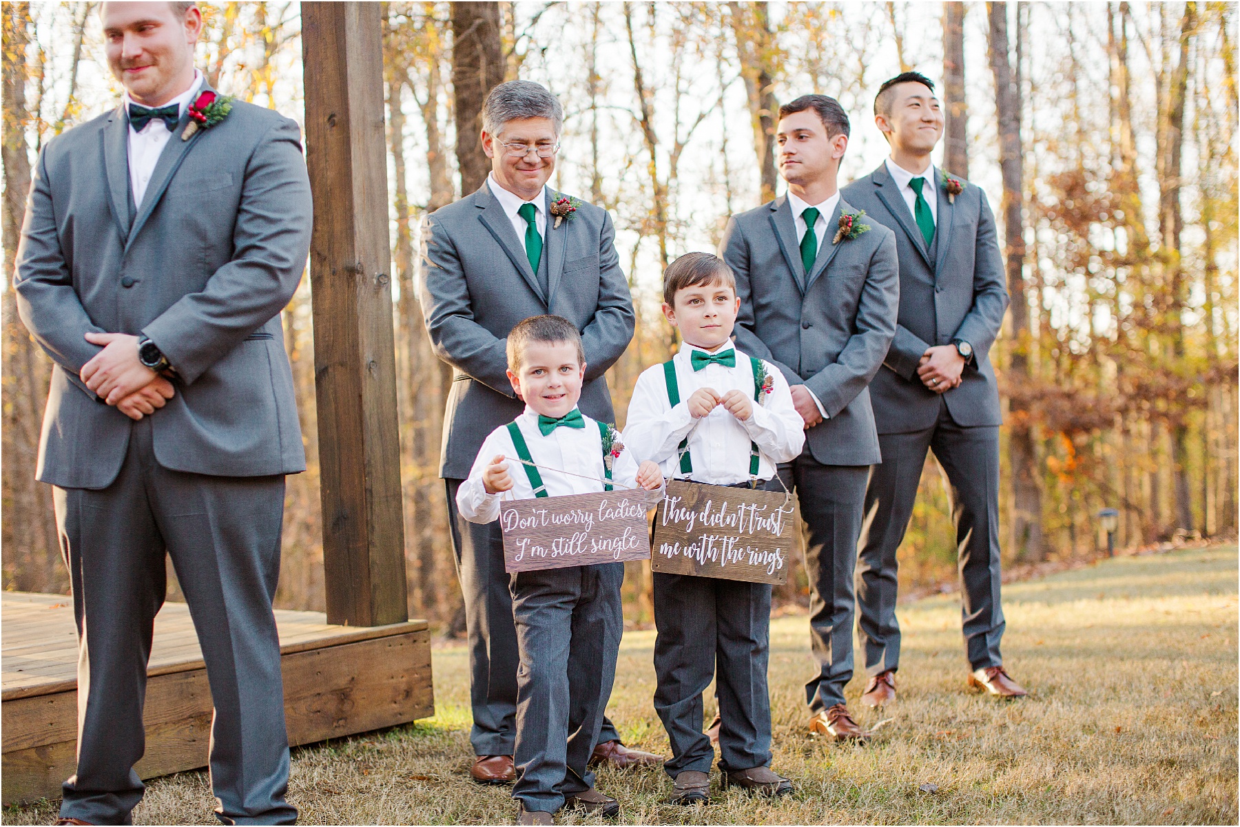 ring bearers hold wooden signs at front of ceremony