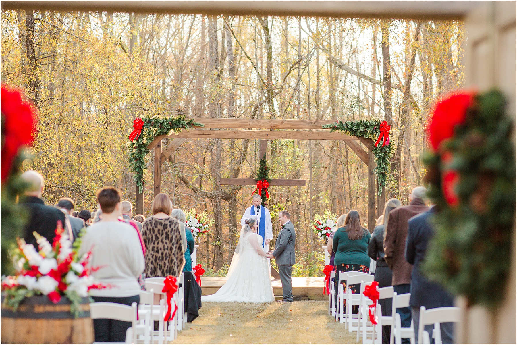 bride and groom facing each other in front of priest