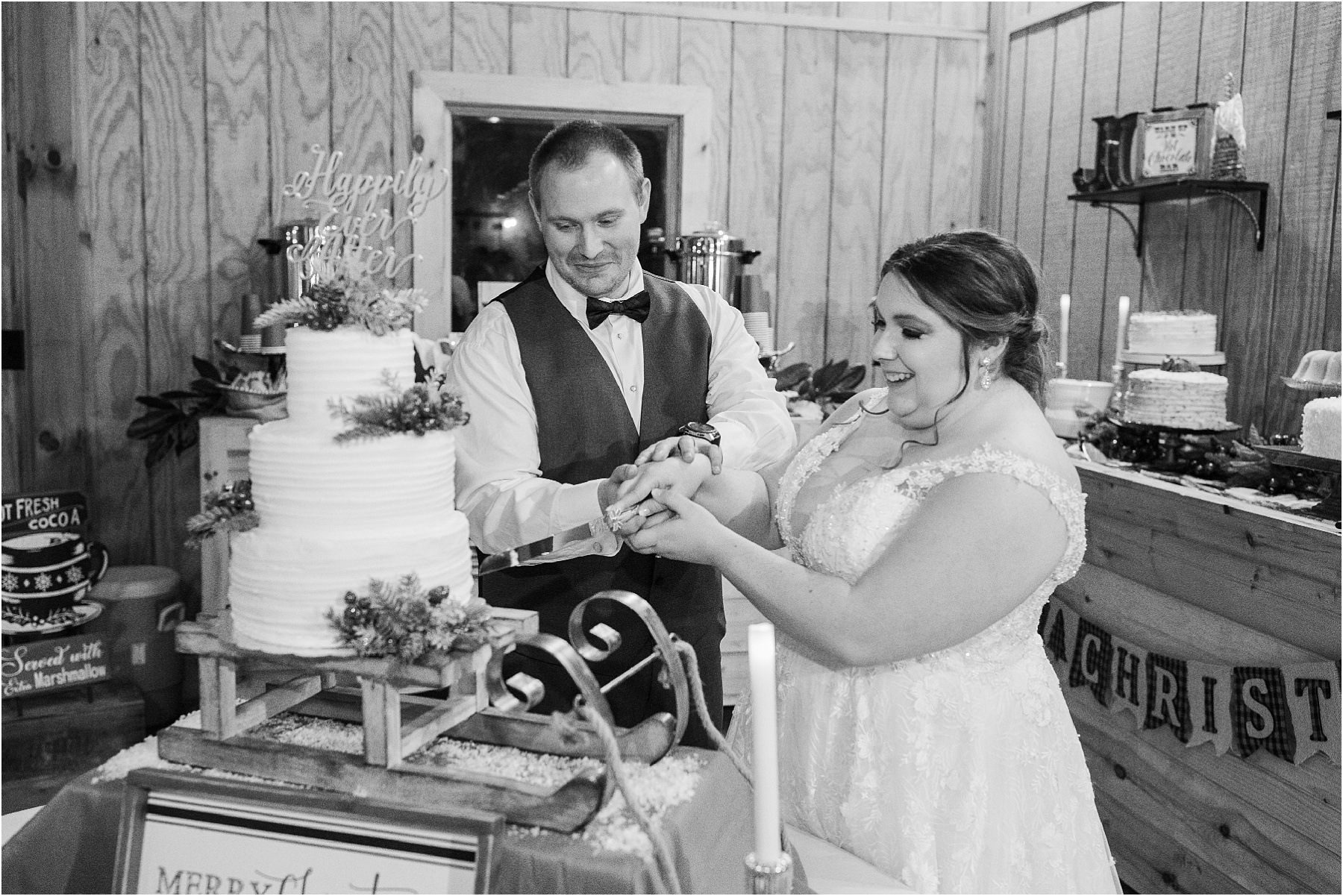 bride and groom cutting their wedding cake at a christmas wedding