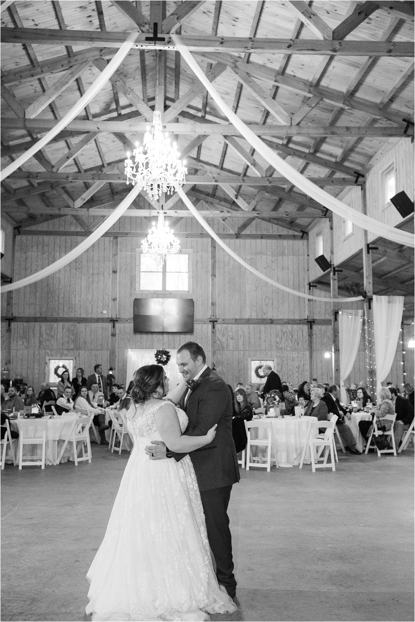 newlyweds dance in front of guests at a barn venue