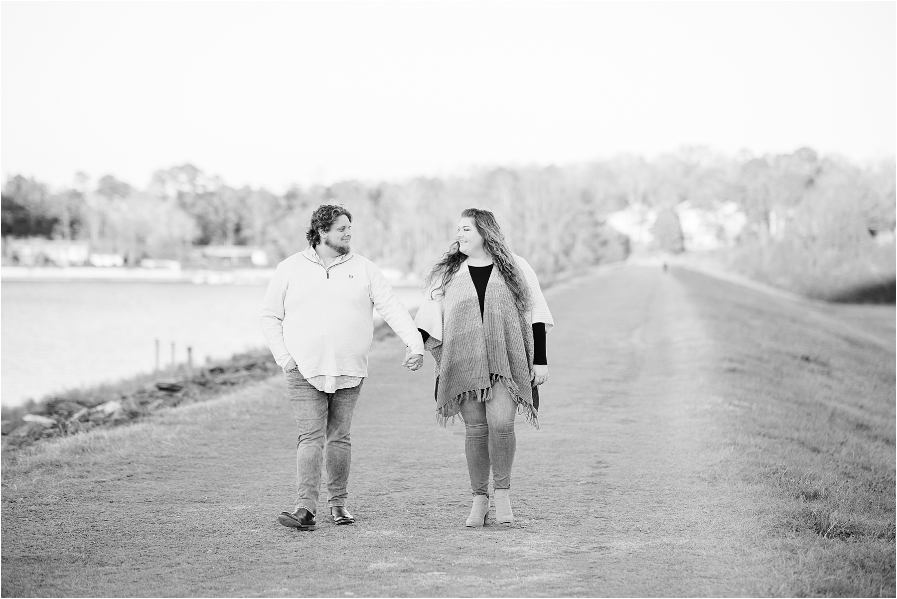 Engaged couple walking on Clemson Dam