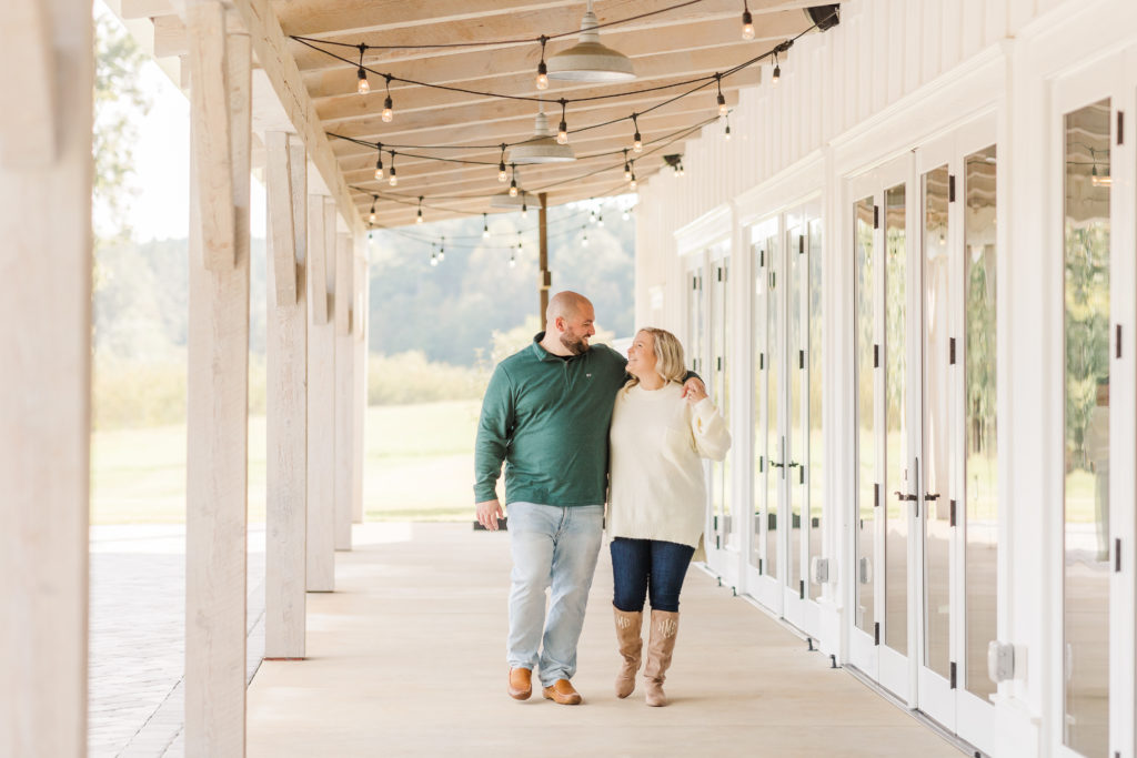 couple walking next to heyward manor barn
