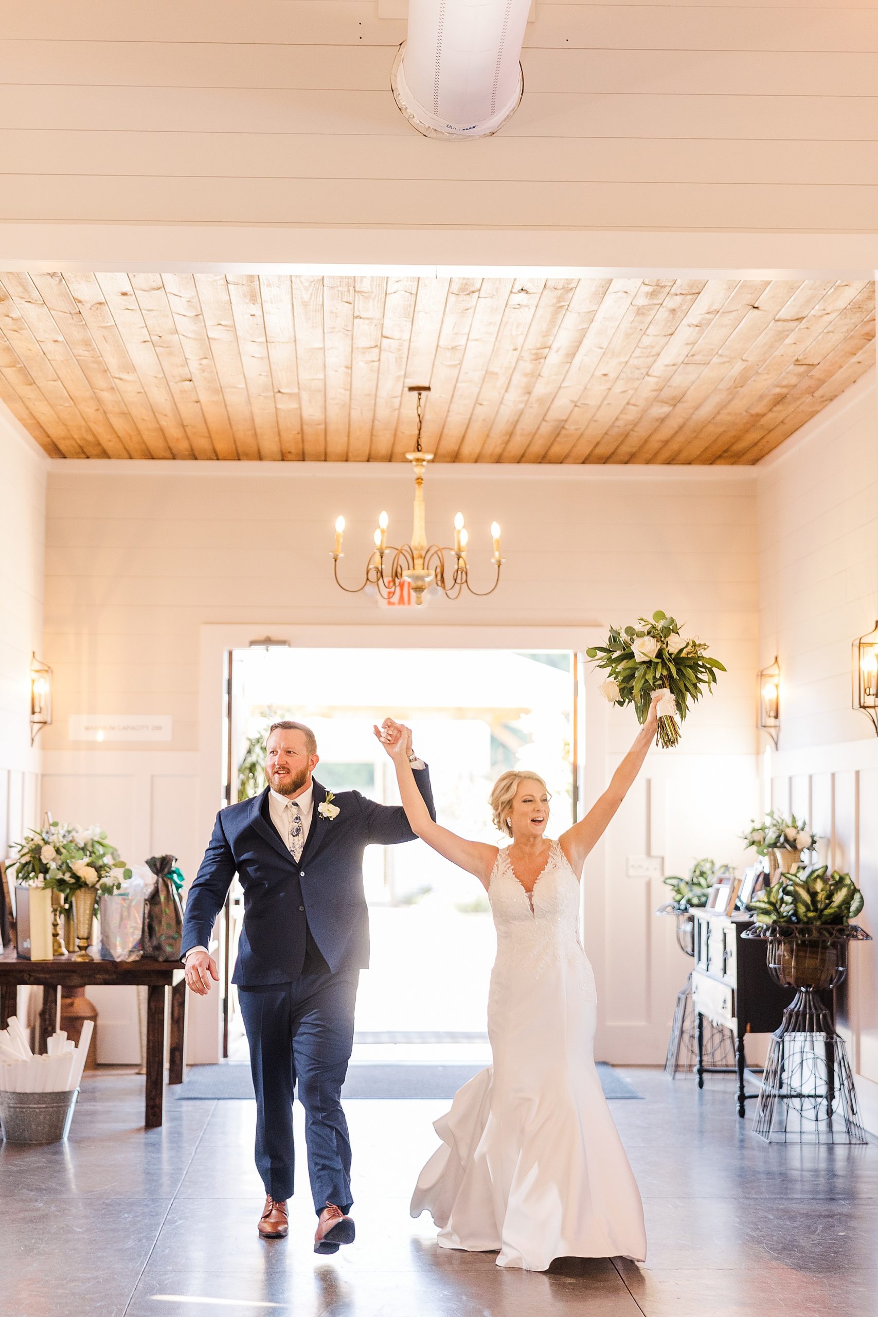 groom and bride walking into reception venue