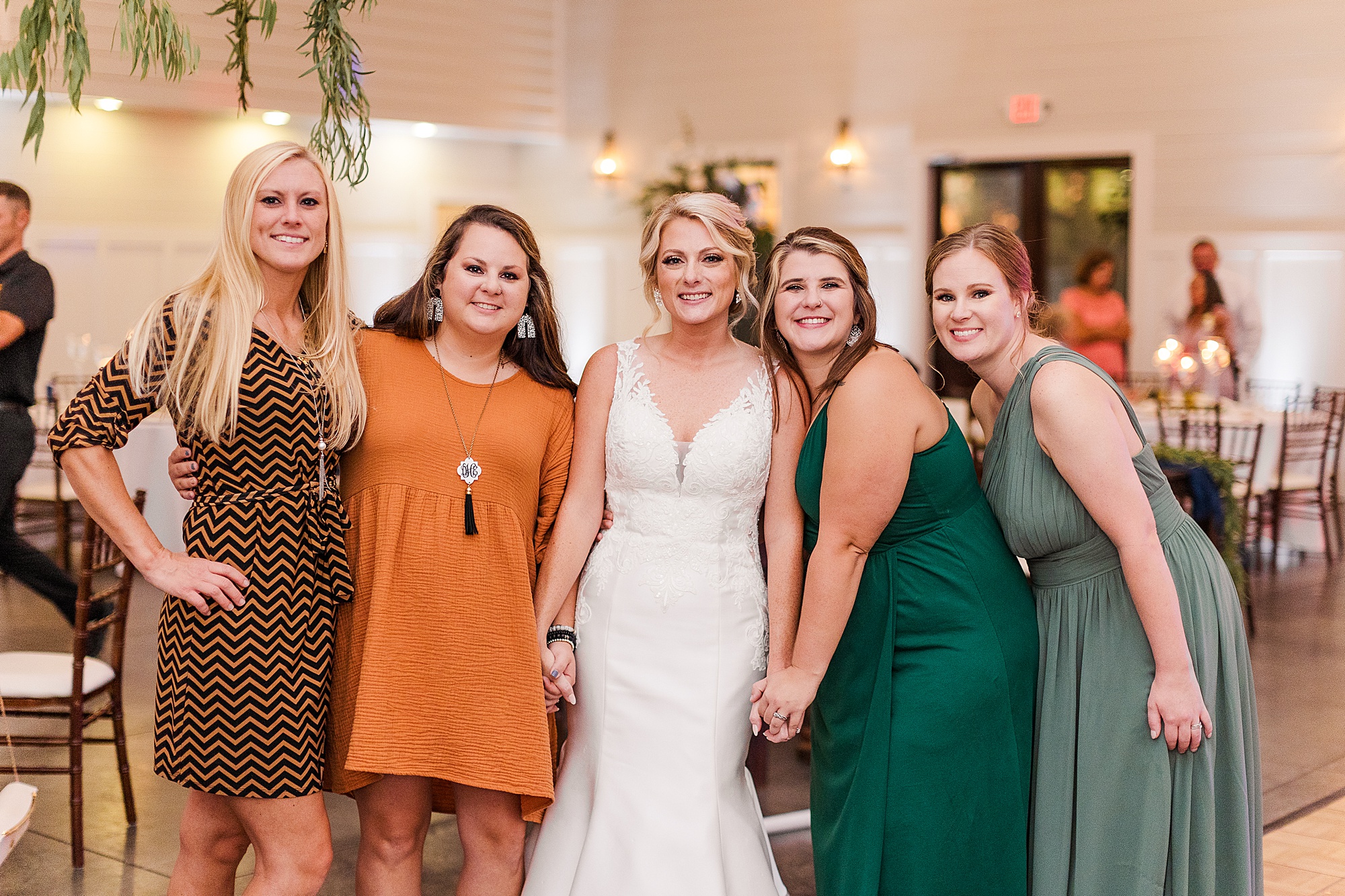 Bride posing with her friends at a wedding
