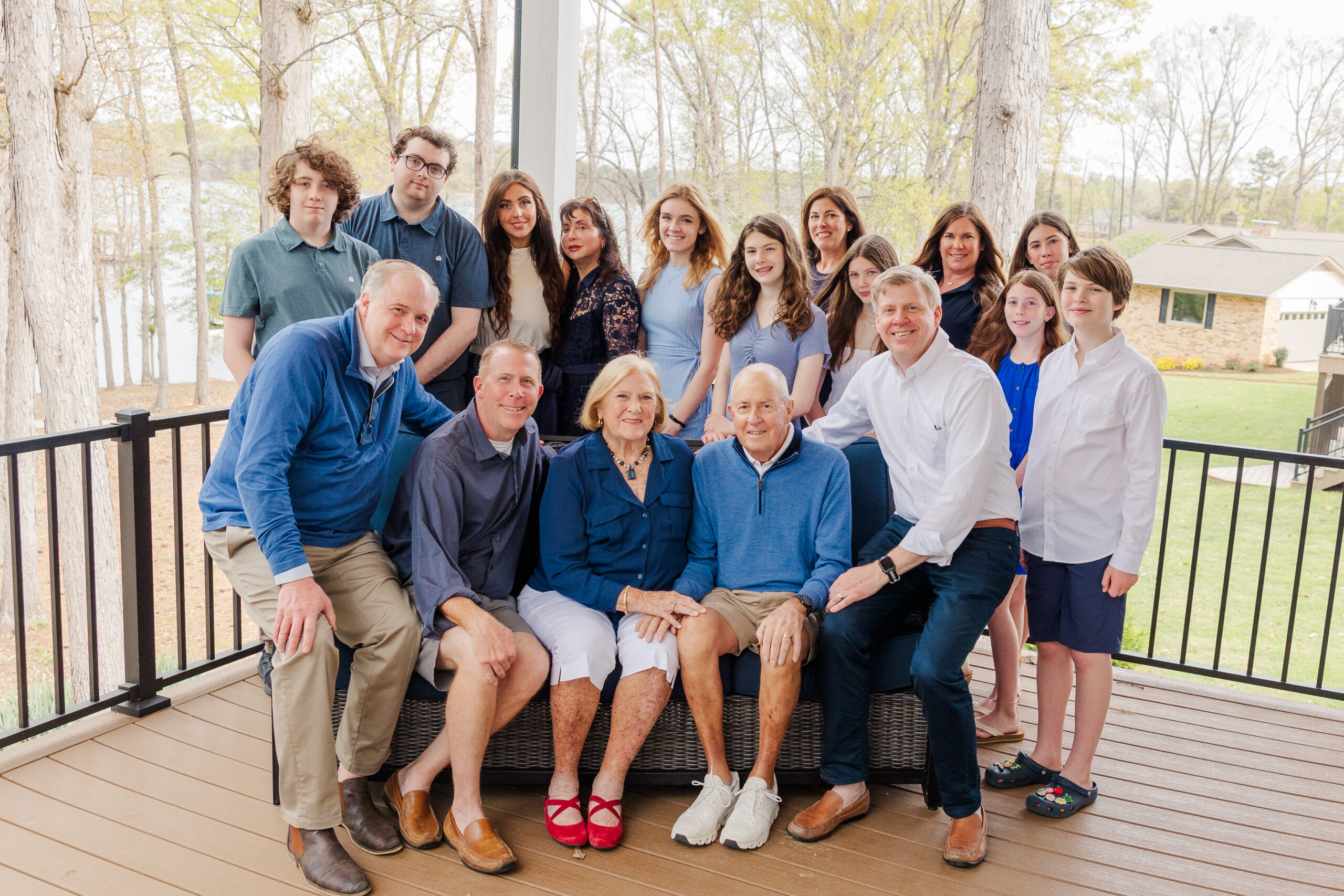 large extended family posing for a picture on their lake house